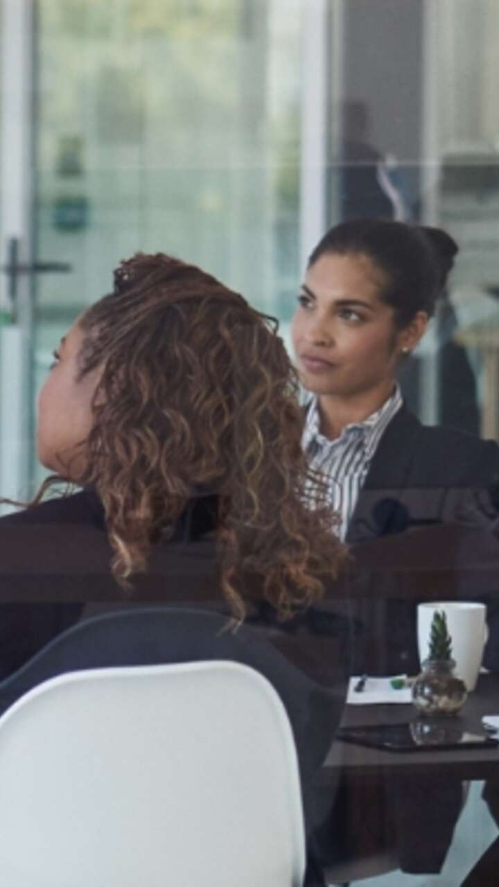 /people-in-meeting-looking-at-speaker-in-corporate-office