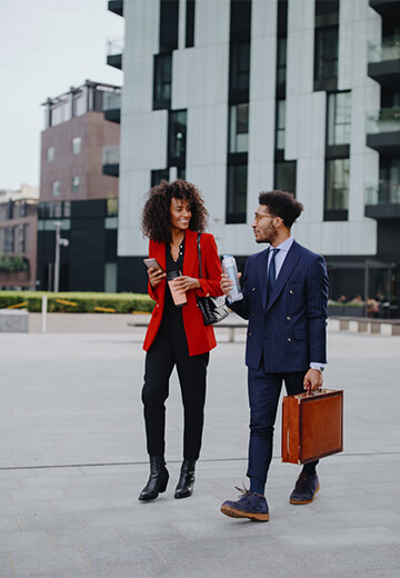 couple-in-office-attire-walking-business-district-outdoors-bdo