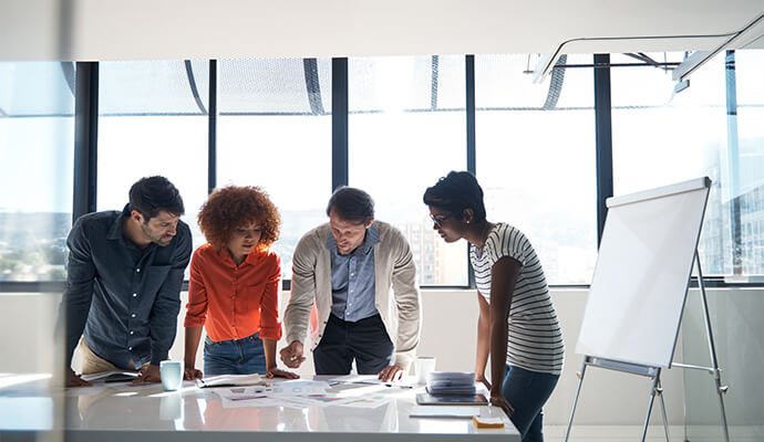 group-of-people-looking-at-papers-in-office-bdo