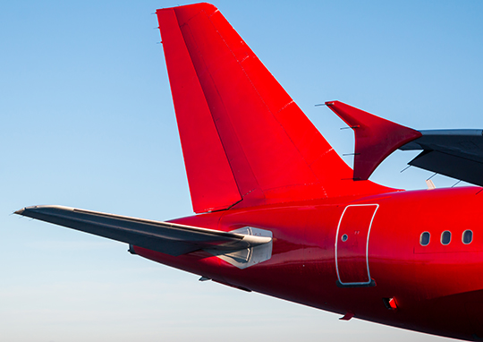 tail-rear-passenger-airplane-red-color-against-blue-sky-