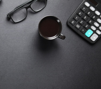 black-glasses-black-cup-black-calculator-on-black-table-bdo