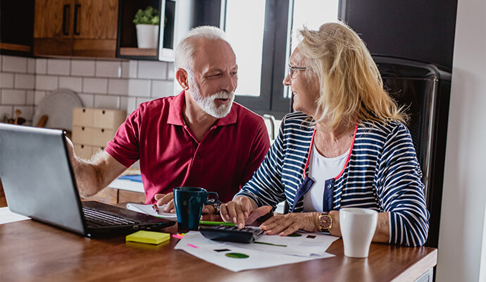 senior-couple-at-kitchen-counter-accounting-smiling-bdo