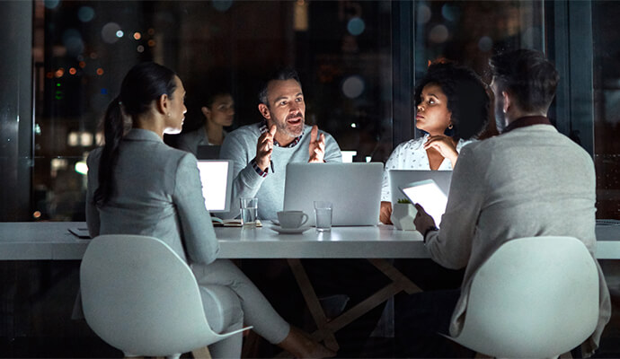 people-in-meeting-night-setting-office-reflections-bdo