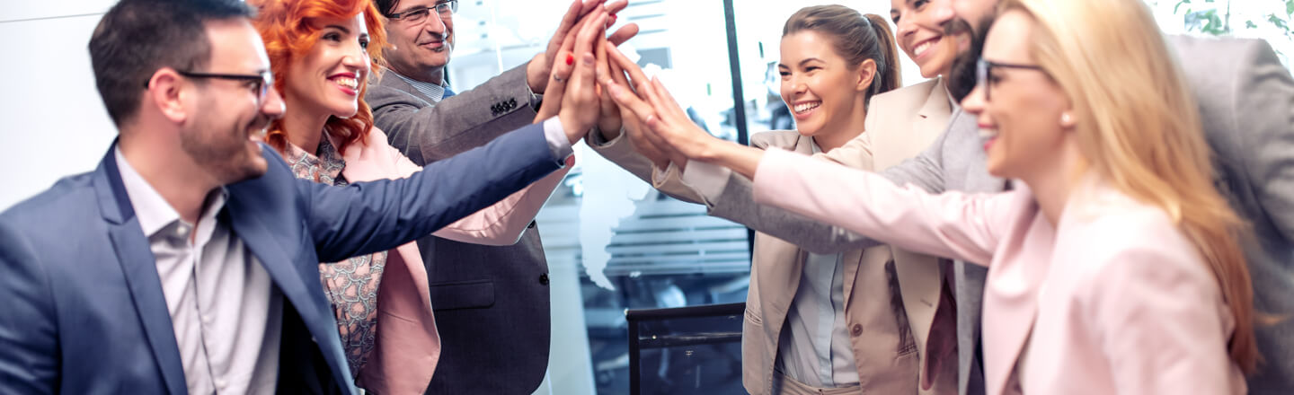 team-in-office-setting-high-fiving-teamwork-bdo