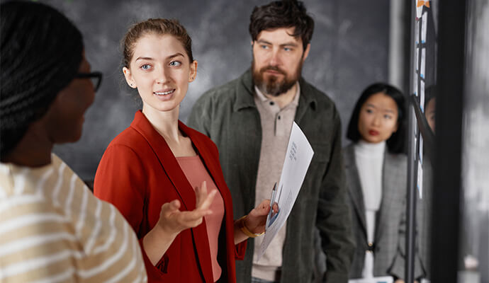 woman-in-red-suit-talking-to-colleagues-bdo