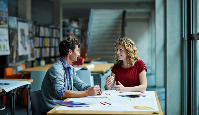 couple-conversating-in-office-setting-by-the-window-bdo
