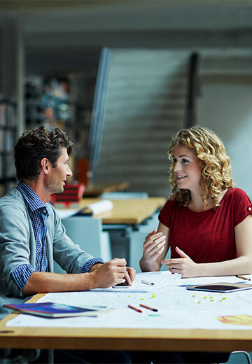 couple-conversating-in-office-setting-by-the-window-bdo
