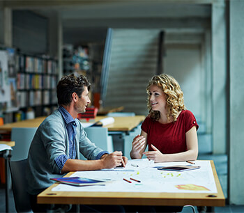 couple-conversating-in-office-setting-by-the-window-bdo