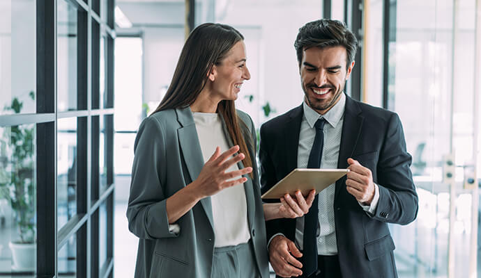 couple-laughing-on-tablet-in-open-office-space-bdo