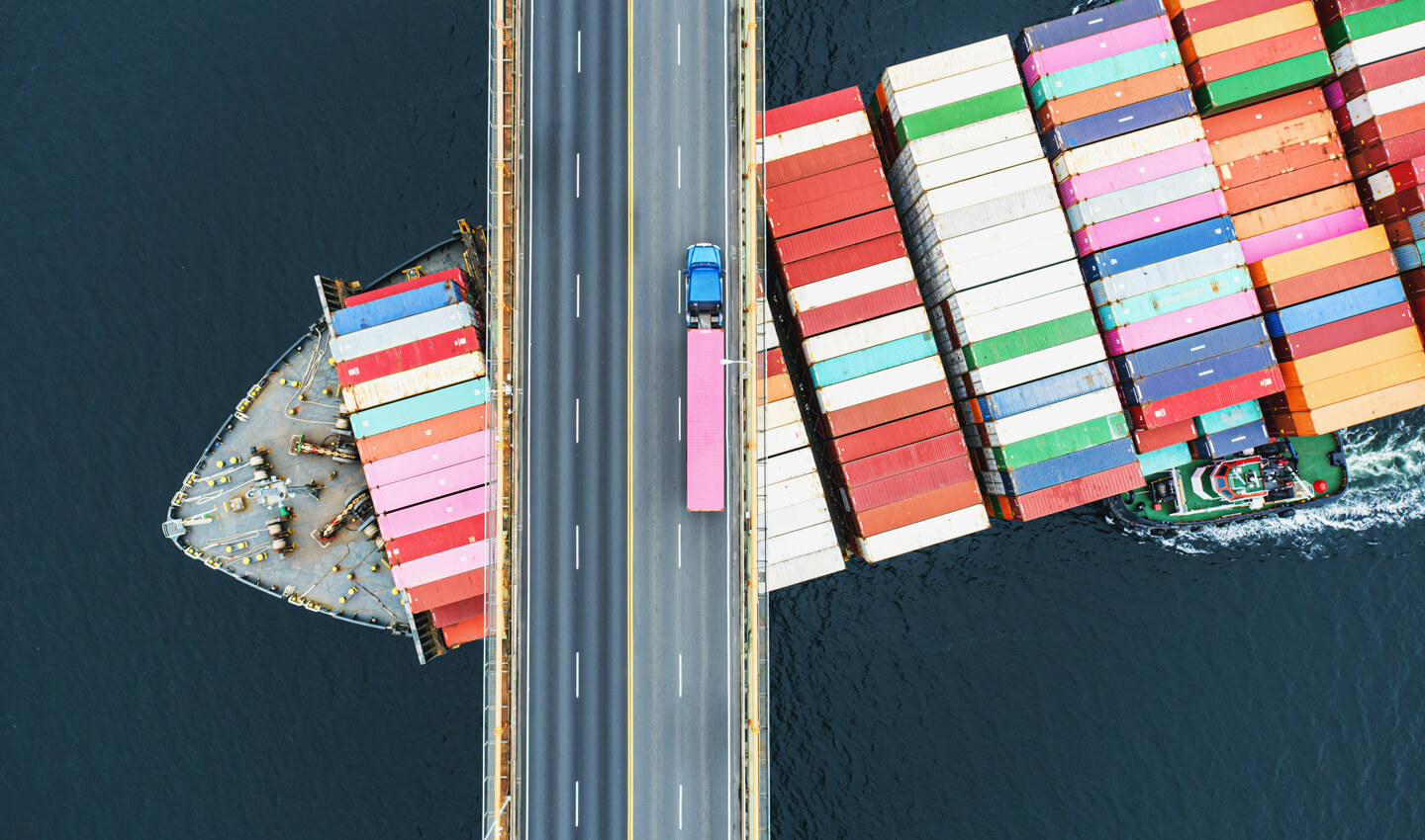 container-ship-sailing-under-motorway-bridge-customs-bdo