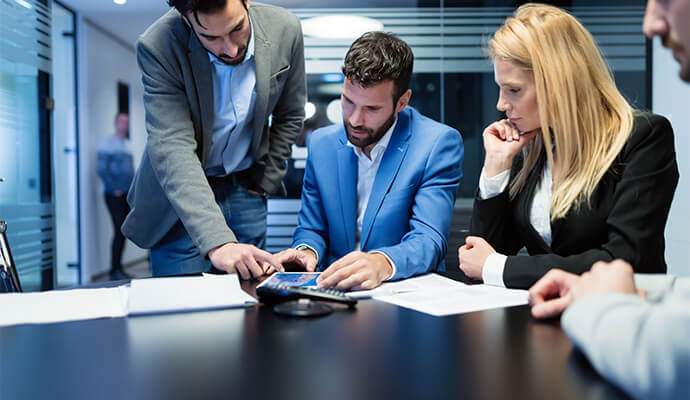 people-looking-at-documents-on-table-bdo