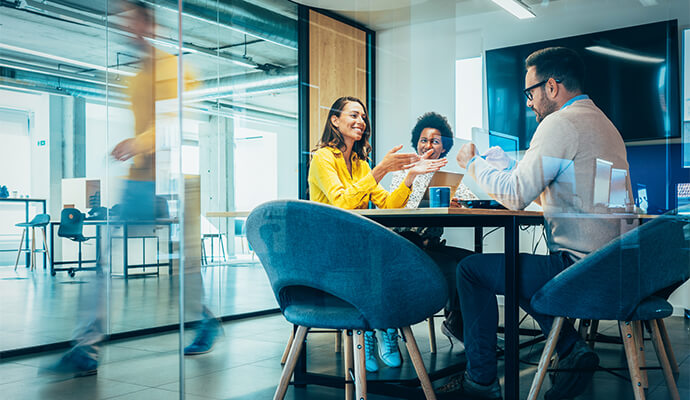 people-smiling-in-meeting-room-seen-through-glass-window-bdo