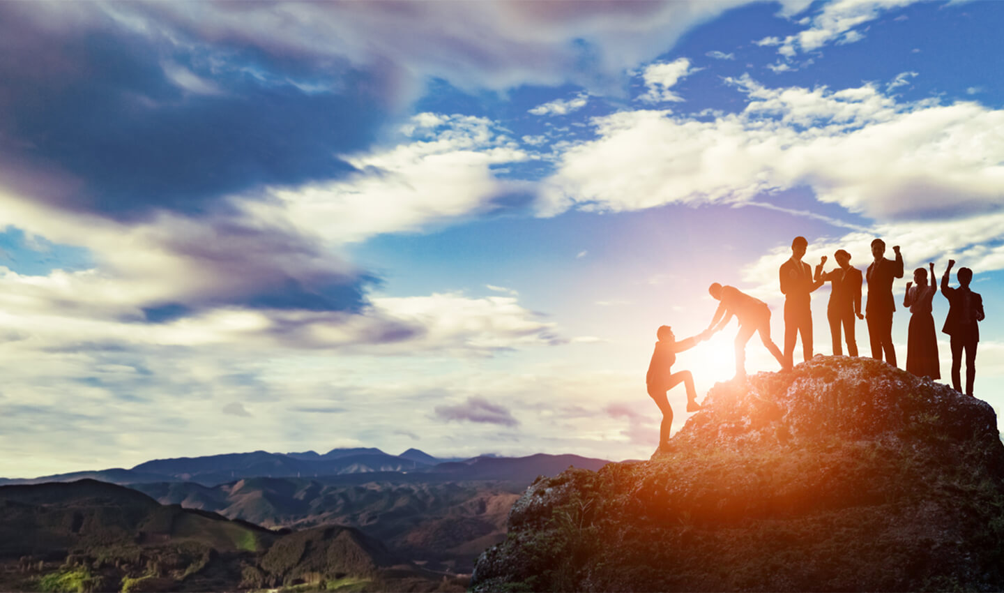 people-celebrating-on-clifftop-against-the-sun-mountain-landscape-bdo