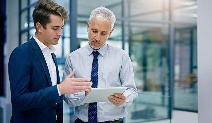 two-men-discussing-project-over-tablet-bdo