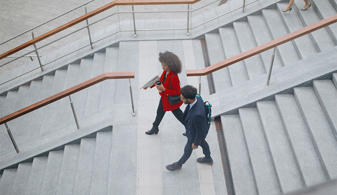 couple-in-office-attire-walking-down-the-stairs-outdoors-bdo