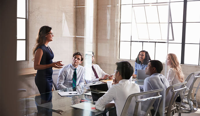 people-smiling-in-meeting-room-seen-through-glass-window-bdo