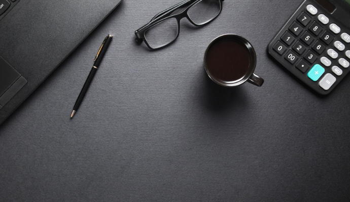 black-eyeglasses-black-cup-black-calculator-on-black-table-bdo