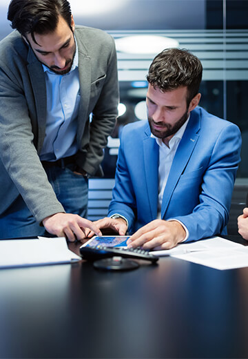 people-looking-at-tablet-in-conference-room-office-setting