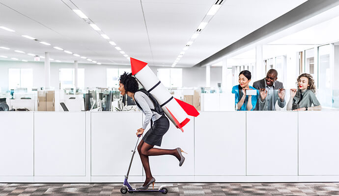 girl-on-heels-scooting-in-office