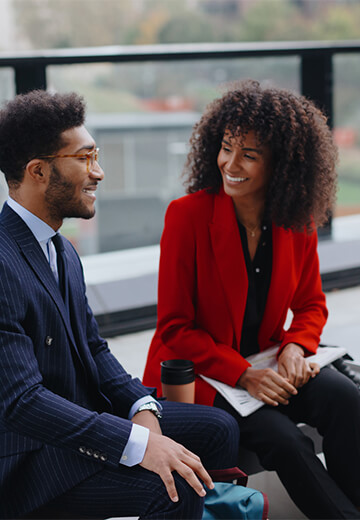 couple-in-office-attire-talking-business-ditrict-outdoors-bdo