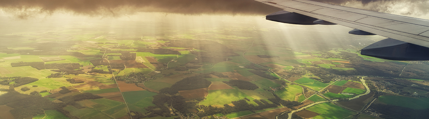 white-airliner-over-irish-landscape