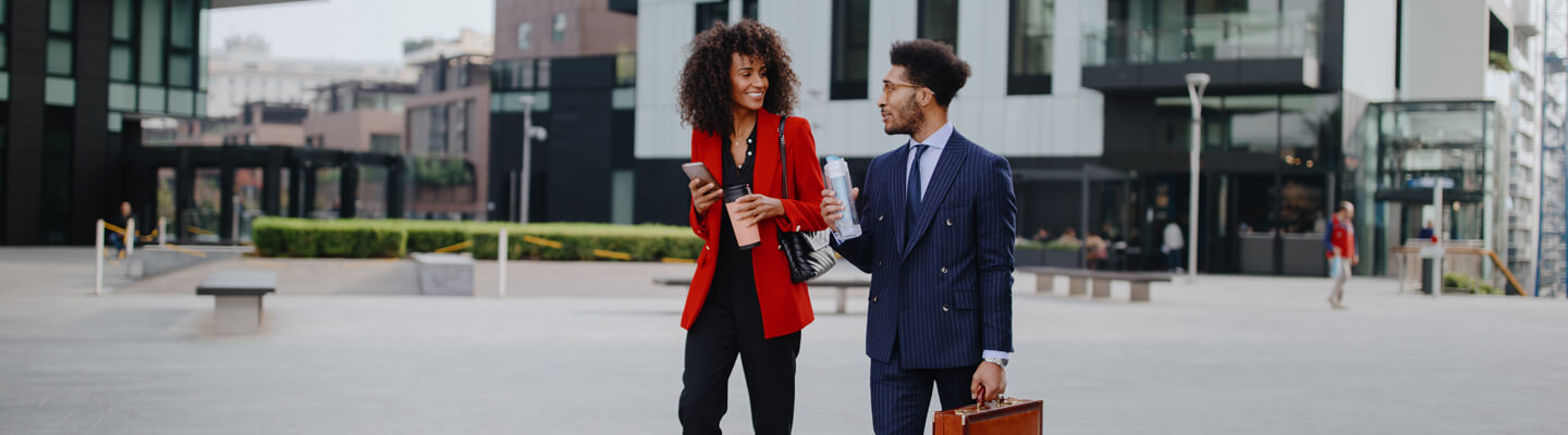 couple-in-office-attire-walking-business-district-outdoors-bdo
