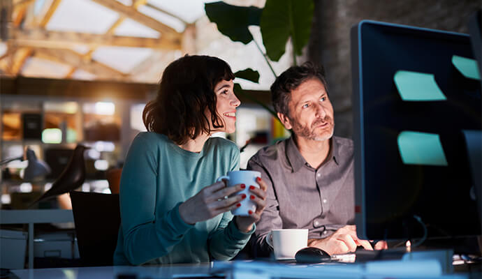 couple-looking-at-computer-screen-working-from-home