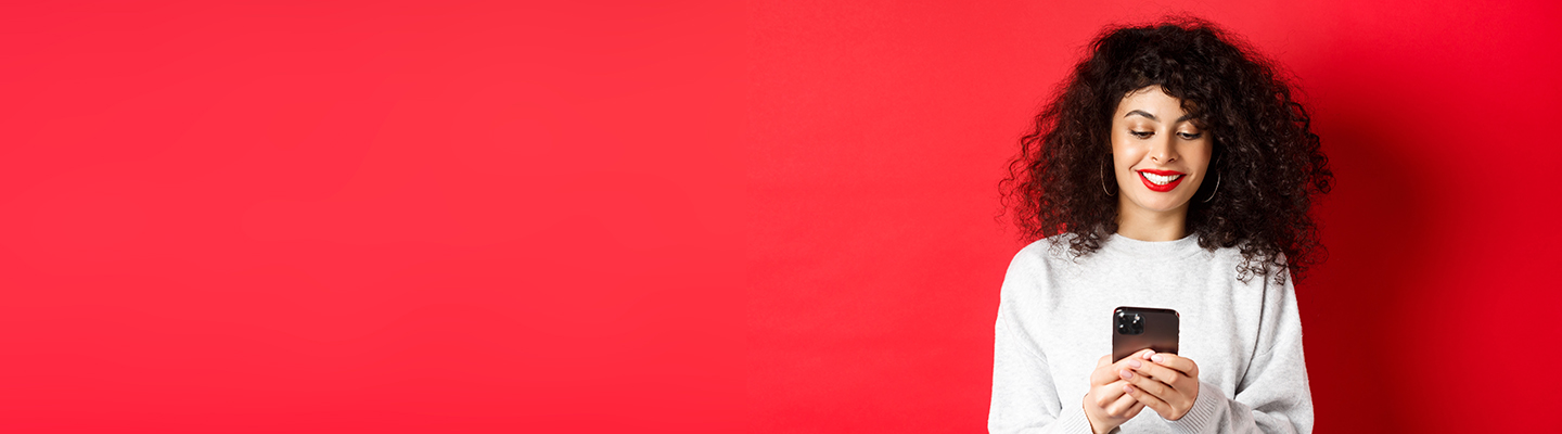 young-woman-standing-against-red-background