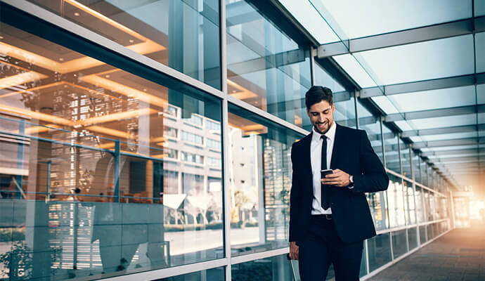 man-in-suit-on-the-phone-building-reflection-bdo