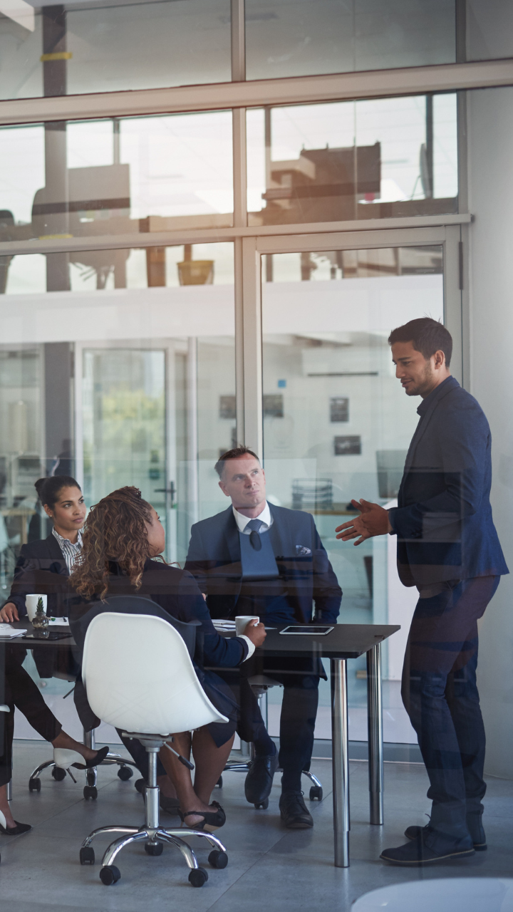 people-in-meeting-looking-at-speaker-in-corporate-office-