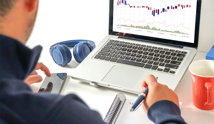 over-the-shoulder-view-of-man-working-with-data-laptop-bdo