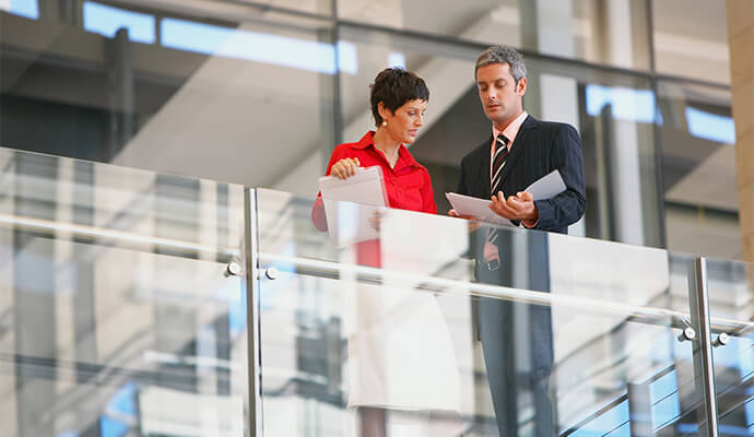 couple-in-office-setting-looking-at-documents-by-banister-bdo