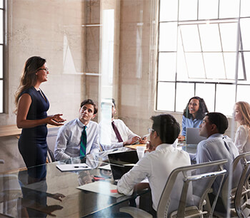 people-smiling-in-meeting-room-seen-through-glass-windows-reflections-bdo