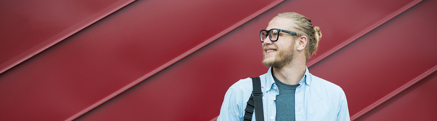 front-view-cheerful-man-against-red-background
