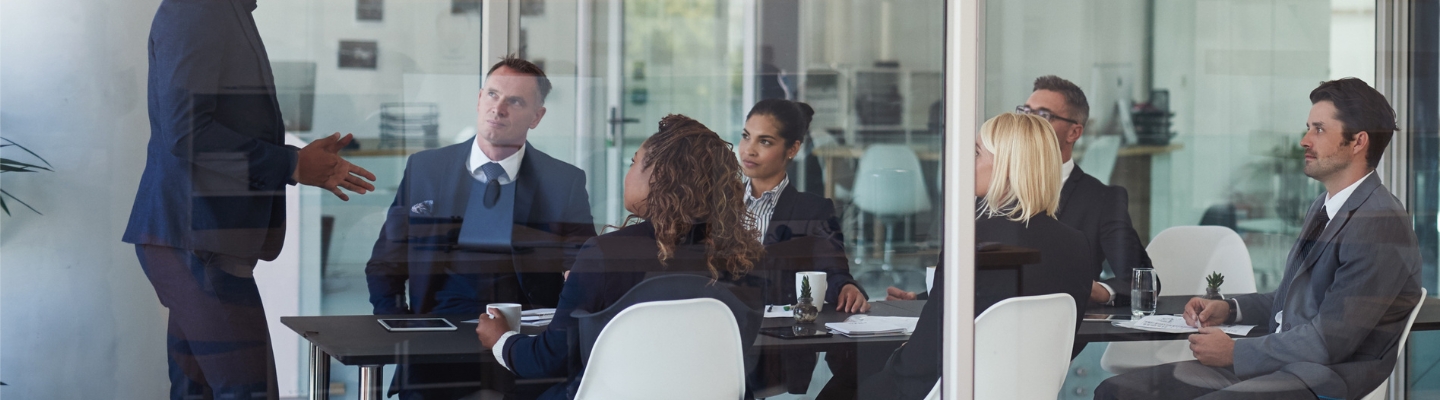people-in-meeting-looking-at-speaker-in-corporate-office-