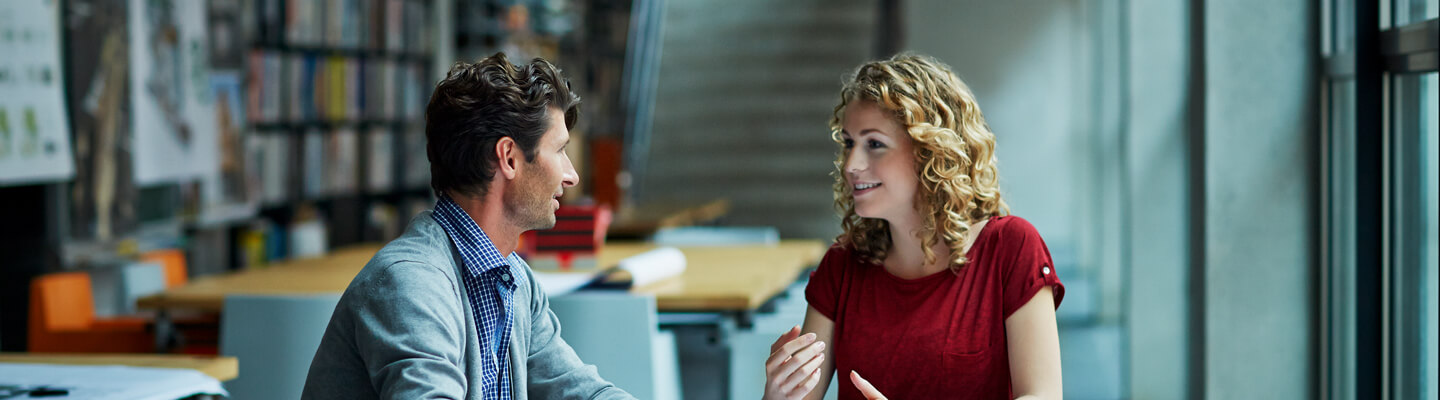couple-conversating-in-office-setting-by-the-window-bdo